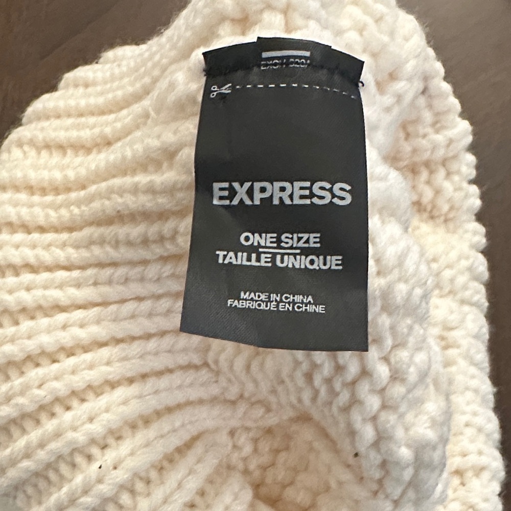 Express Fuzzy Pom Pom Beanie in a cream cable-knit - Picture 2 of 3